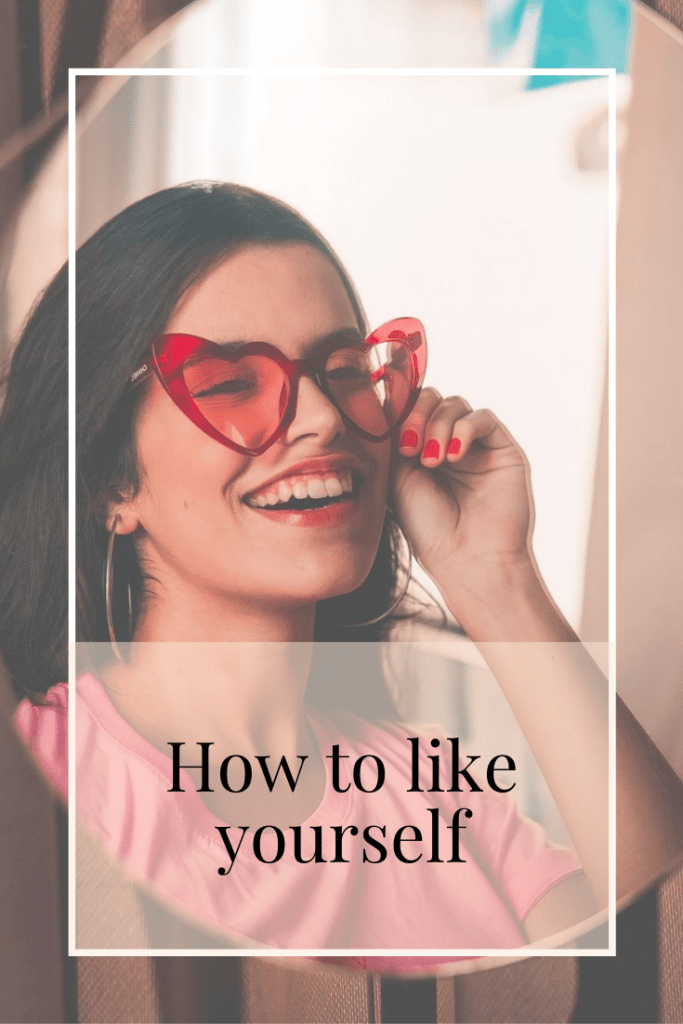 title photo woman smiling into mirror wearing heart shaped glasses